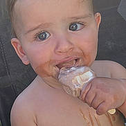 Chester is registered to the contest to win money with this photo: child, toddler, ice_cream, chocolate, messy, outdoor, summer, happy, cute, eating, food, face, hand, skin, sitting, chair, closeup, mouth, fun, playful