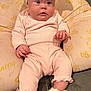 Brooklynne joined the competition — help win amazing prizes! baby, infant, pink_clothing, headband, bow, unicorn_slippers, cushion, princess_theme, soft_fabric, cute, sitting, indoors, child, pajamas, footwear, plush, adorable, portrait, cozy, young_child