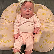 Brooklynne joined the competition — help win amazing prizes! baby, infant, pink_clothing, headband, bow, unicorn_slippers, cushion, princess_text, soft_toys, indoor, cute, child, portrait, sitting, cozy, comfortable, plush, home, adorable, young_child