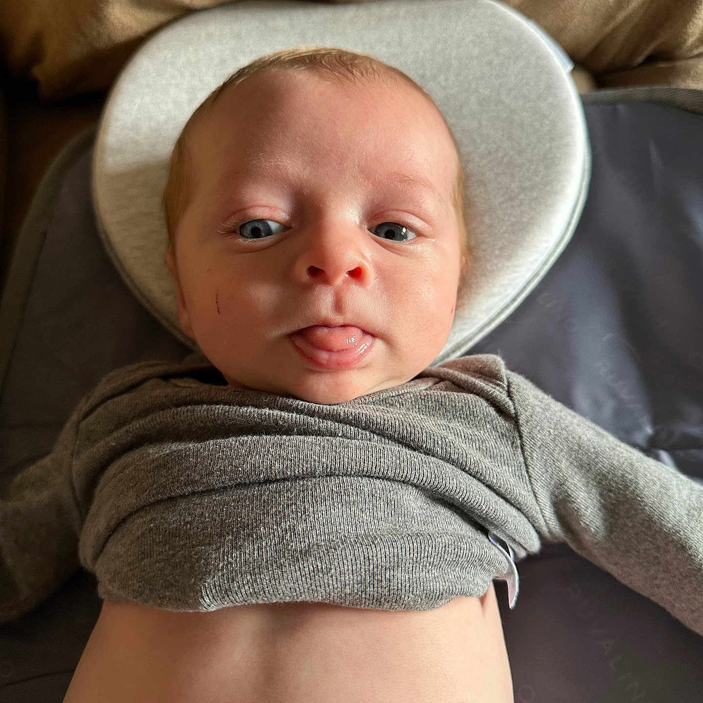 Bentley is registered to the contest to win money with this photo: baby, blanket, bonnet, cap, clothing, couch, cushion, face, furniture, happy, hat, head, homedecor, newborn, person, photography, portrait, smile, sunhat, towel