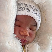 Harlow-Rae joined the competition — help win amazing prizes! baby, bodypart, bonnet, cap, clothing, coat, face, finger, hand, hat, head, hood, hoodie, jacket, knitwear, newborn, person, photography, portrait, sleeping