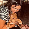 woman, puppy, dog, pet, hugging, night, outdoor, love, affection, dark_hair, patterned_shirt, leash, sand, lights, candid, portrait, animal, cute, warm, bond