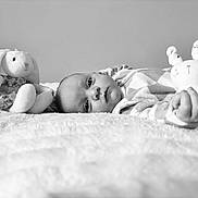 Bonnie joined the competition — help win amazing prizes! baby, plush_toy, bunny, blanket, infant, soft_toy, monochrome, portrait, child, sleepwear, cute, lying_down, peaceful, close_up, indoor, toy, face, hand, cozy, comfort