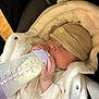 baby, bottle, sleeping, hat, blanket, infant, feeding, cozy, clothing, car_seat, child, cute, peaceful, napping, soft, warm, newborn, hand, face, portrait