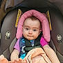 baby, car_seat, seatbelt, pink_headrest, blanket, drool, infant, child, blue_eyes, clothing, soft_toy, sitting, cute, portrait, indoor, safety, child_seat, expression, hands, closeup