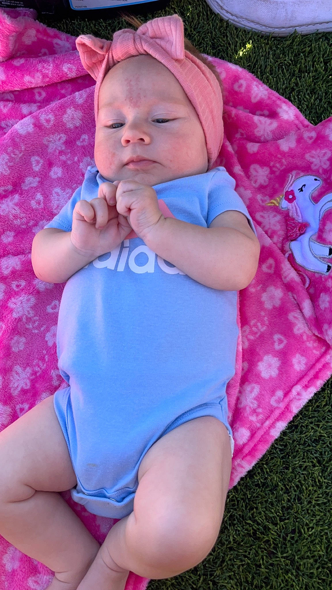 Denzleigh is registered to the contest to win money with this photo: baby, baby_toddler_clothing, child, cool, electric_blue, eye, finger, fun, grass, happy, lip, magenta, pattern, person, pink, purple, red, skin, thigh, toddler