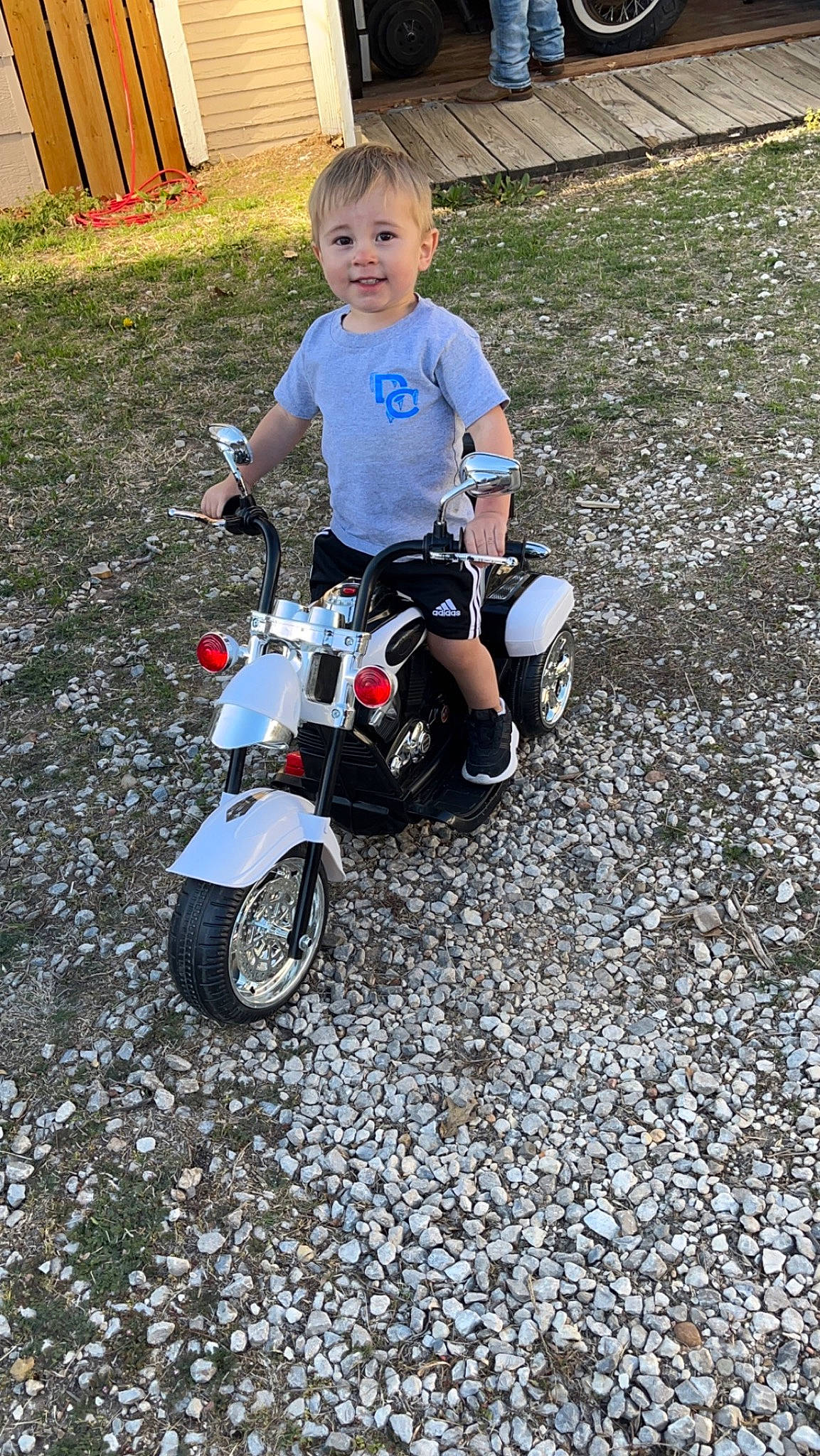 Drew joined the competition — help win amazing prizes! asphalt, automotive_design, automotive_lighting, automotive_tire, automotive_wheel_system, baby_toddler_clothing, bicycle_accessory, fender, grass, joy, motor_vehicle, person, riding_toy, rim, road_surface, rolling, shorts, smile, tire, toddler