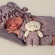 Eve joined the competition — help win amazing prizes! baby, newborn, sleeping, teddy_bear, stuffed_animal, hat, bonnet, clothing, cozy, soft_texture, cute, infant, peaceful, portrait, child, pink, fabric, resting, cute_outfit, indoor