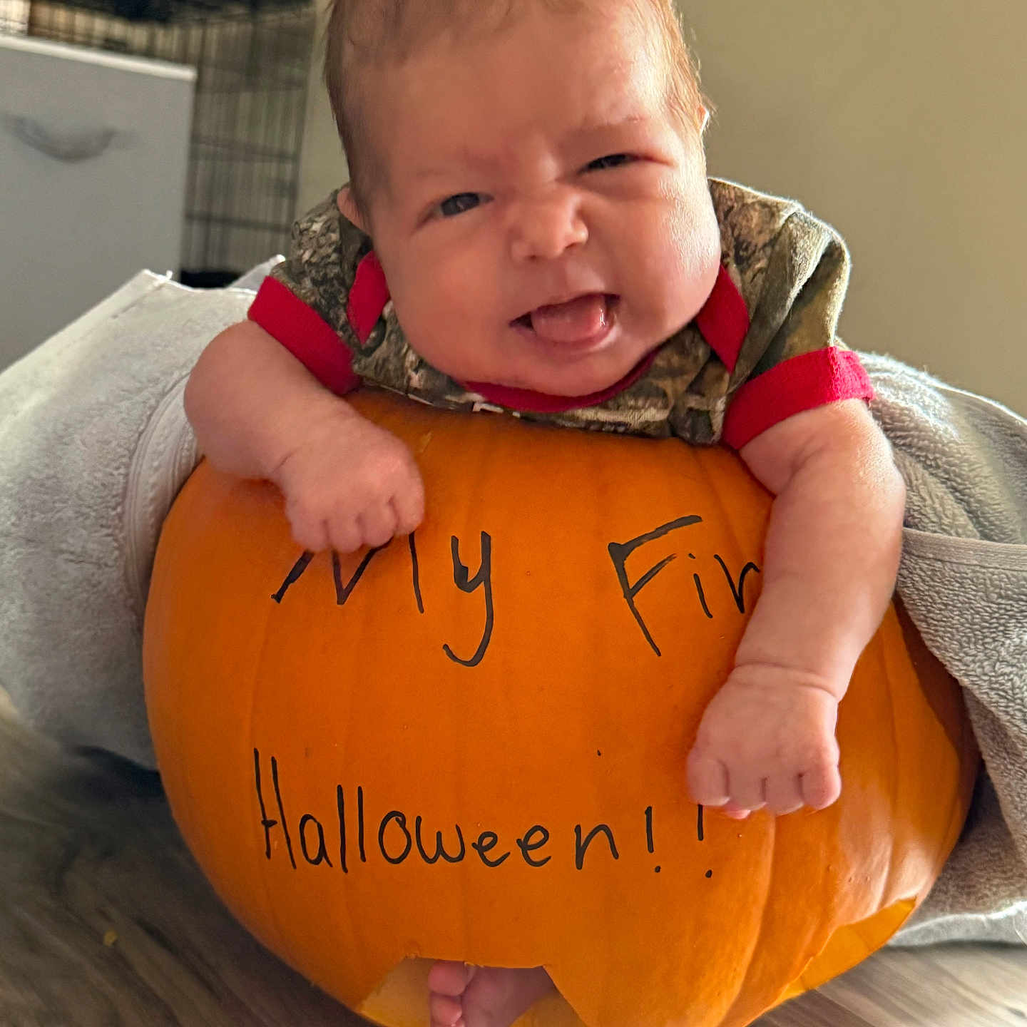 Jameson is registered to the contest to win money with this photo: baby, bodypart, clothing, face, festival, finger, food, hand, head, newborn, person, photography, plant, portrait, produce, pumpkin, sphere, squash, t_shirt, vegetable