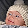 Moreira Iris participe au concours pour gagner de l'argent avec cette photo : baby, blanket, child, close_up, cozy, cute, expression, eyes, face, hat, headwear, infant, knitted_hat, newborn, pom_pom, portrait, smile, soft_texture, warm, wrapped