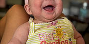 Journie joined the competition — help win amazing prizes! baby, infant, smiling, happy, headband, bow, yellow_stripes, clothing, portrait, cute, child, skin, face, arms, legs, sitting, indoors, blurred_background, person, joy