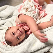 Hurrem joined the competition — help win amazing prizes! baby, smiling, blanket, pink_clothing, headband, infant, indoor, happy, cute, toddler, soft_texture, reaching_out, closeup, portrait, lying_down, child, skin, face, baby_girl, cozy