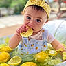 baby, child, lemon, yellow_headband, blue_overalls, water, fruit, slice, hand, face, expression, outdoor, tub, flower_decoration, cute, curious, skin, person, summer, playful