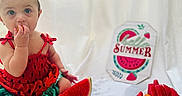Hurrem is registered to the contest to win money with this photo: baby, child, watermelon, fruit, plate, ice_cubes, orange_fruit, sign, summer, clothing, headband, sitting, food, snack, cute, indoor, white_background, portrait, colorful, happy