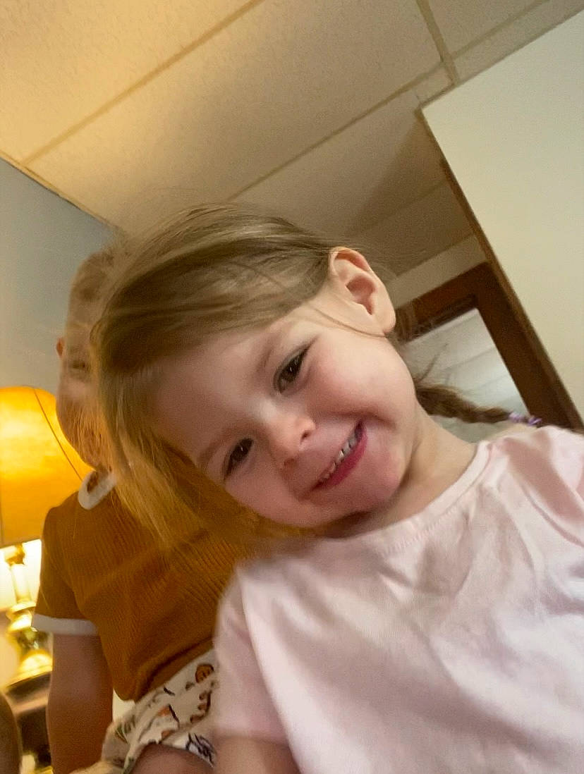 Arayah joined the competition — help win amazing prizes! baby_toddler_clothing, blond, ceiling, cheek, child, flooring, fun, happy, jaw, joy, lamp, laugh, linens, person, room, sitting, smile, t_shirt, toddler, vacation