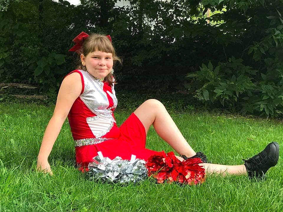 Destiny is registered to the contest to win money with this photo: botany, dress, flower, fun, grass, joy, lady, lawn, meadow, person, photo_shoot, plant, shrub, sitting, summer