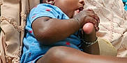 Kai'Ir And Kaidin is registered to the contest to win money with this photo: baby, blanket, blue_clothing, bracelet, chewing, child, closeup, cute, earring, foot, hand, indoor, infant, laying_down, person, portrait, relaxing, skin, texture, young_child