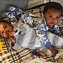 baby, babies, child, infant, playpen, blanket, pajamas, toy, plaid, indoor, cute, sleepwear, lying_down, face, expression, soft_lighting, comfort, childhood, adorable, young