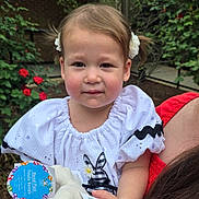 Olive is registered to the contest to win money with this photo: toddler, child, plush_toy, outdoor, garden, flowers, pigtails, white_dress, red_flowers, greenery, cute, portrait, person, holding, young_child, innocence, smile, nature, happy, baby