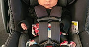 Olive is registered to the contest to win money with this photo: accessories, baby, belt, car, car_interior, carseat, clothing, cushion, doll, dress, face, hat, head, homedecor, person, photography, portrait, toy, transportation, vehicle