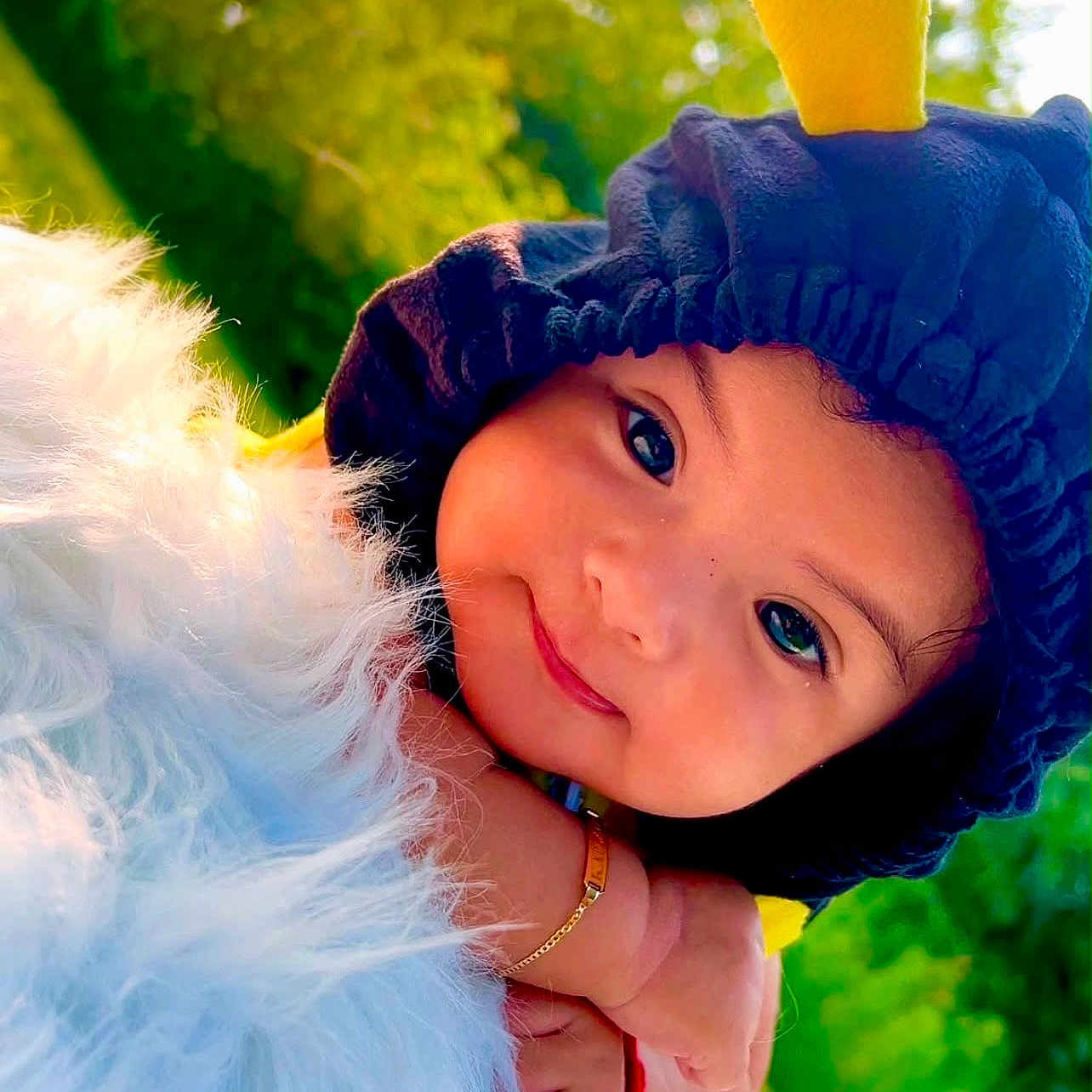 Raelynn is registered to the contest to win money with this photo: toddler, child, smile, face, hat, bee_costume, outdoor, nature, greenery, fluffy, closeup, portrait, happy, cute, baby, arm, bracelet, sunlight, daylight, playful
