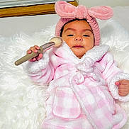 Raelynn joined the competition — help win amazing prizes! baby, child, infant, pink, robe, headband, bunny_ears, makeup_brush, soft_texture, fluffy, white_fur, window, indoor, cute, adorable, cozy, relaxing, portrait, person, toddler