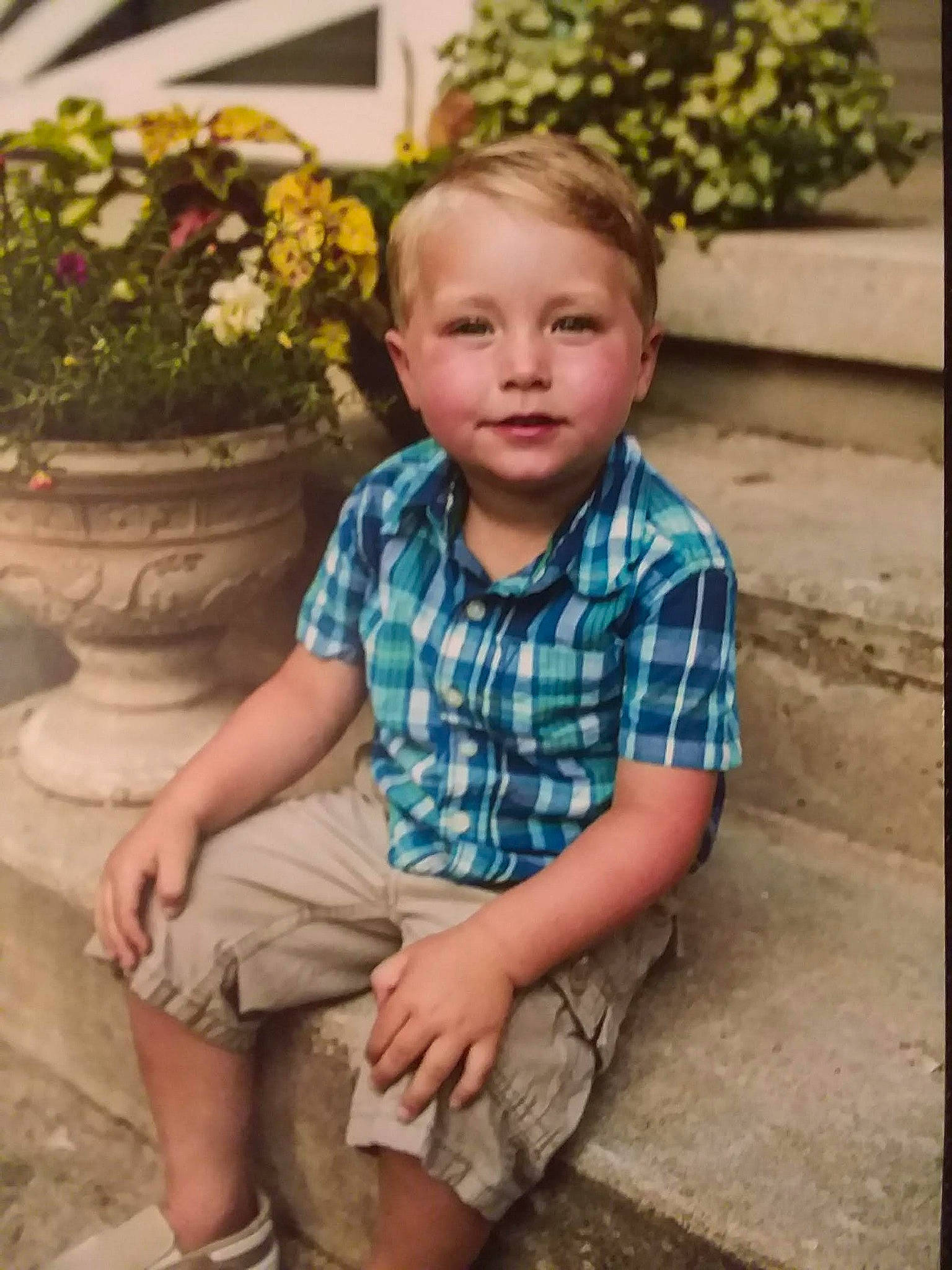 Aiden is registered to the contest to win money with this photo: child, child_model, design, leg, pattern, person, sitting, smile, toddler