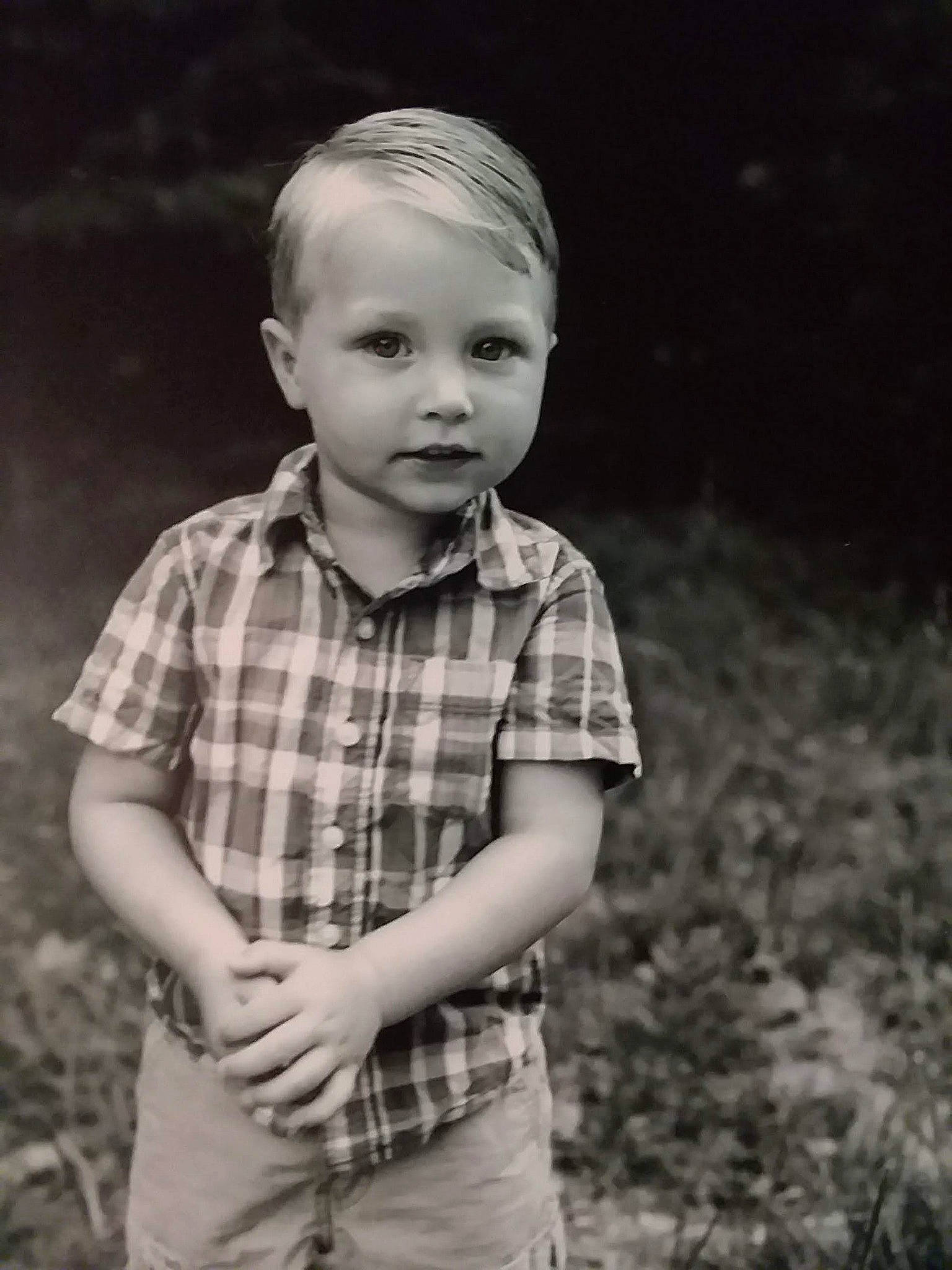 Aiden is registered to the contest to win money with this photo: black_and_white, cheek, child, design, eye, face, head, male, monochrome, monochrome_photography, pattern, people, person, photograph, photography, plaid, portrait, smile, snapshot, standing