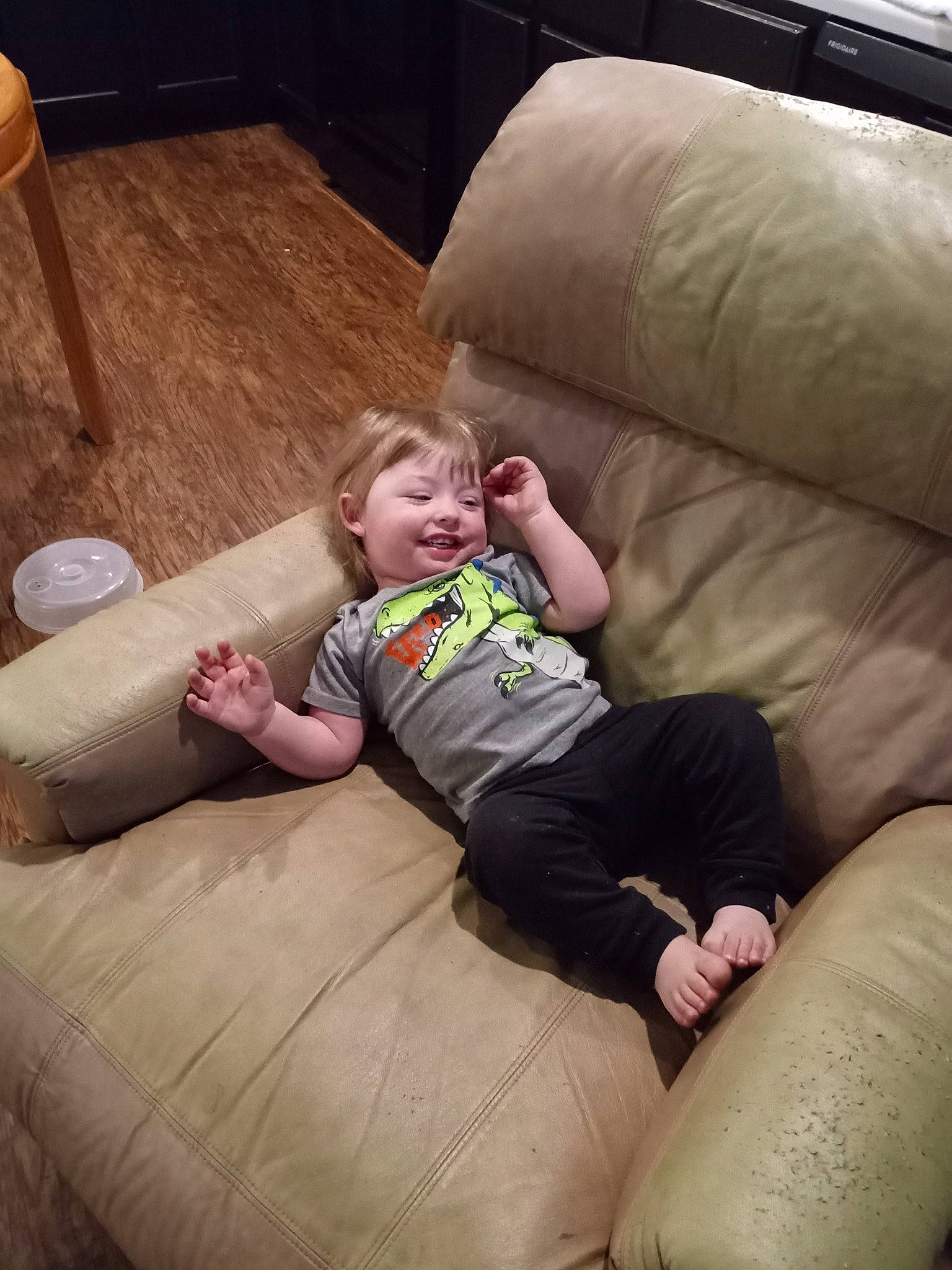 Jayson is registered to the contest to win money with this photo: baby, bean_bag, chair, child, comfort, couch, flooring, fun, furniture, grass, hardwood, joy, lap, leisure, living_room, person, recreation, sitting, smile, toddler