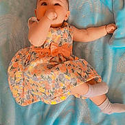 Ever'Leigh joined the competition — help win amazing prizes! baby, child, tiara, dress, floral, blanket, blue, socks, lying_down, thumb_sucking, cute, infant, bracelet, floor, wooden_floor, colorful, sparkly, soft, portrait, indoors