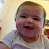 Aurora joined the competition — help win amazing prizes! baby, child, infant, smiling, happy, portrait, close_up, face, eyes, mouth, teeth, white_shirt, short_sleeves, indoor, home, warm_lighting, hand, held, sitting, photography
