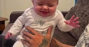 Aurora joined the competition — help win amazing prizes! adult, baby, child, couch, cozy, family, hands, happy, home, indoors, infant, onesie, photography, playful, portrait, sitting, smiling, socks, tattoos, white_outfit