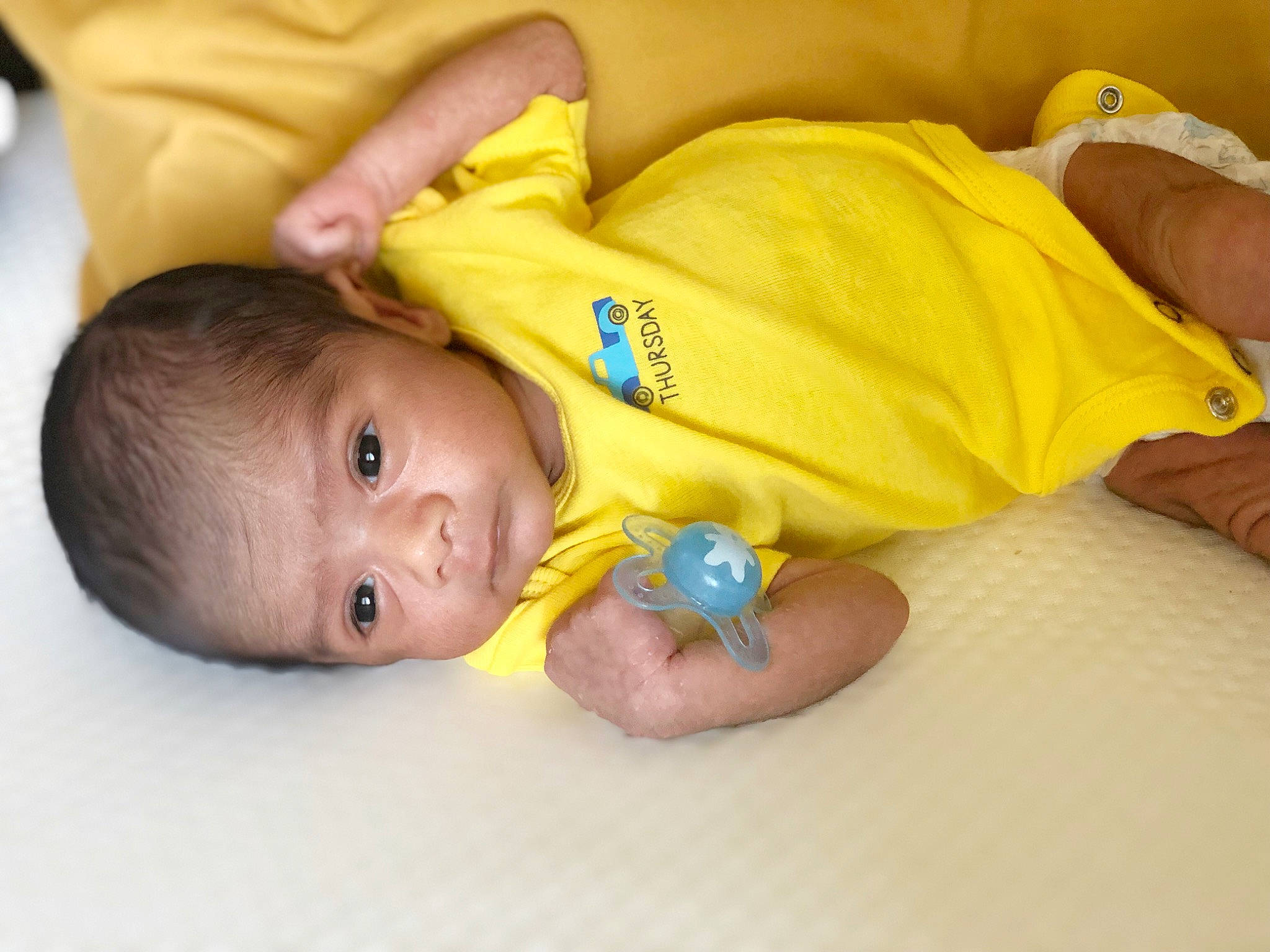 Tihami is registered to the contest to win money with this photo: baby, baby_products, baby_toddler_clothing, bedtime, cheek, child, comfort, elbow, face, finger, flooring, foot, happy, linens, nail, person, room, skin, thumb, toddler