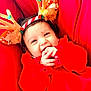 Hitaanshi is registered to the contest to win money with this photo: baby, child, smile, red_clothing, reindeer_antlers, holiday, festive, cute, hands, face, infant, happy, cheerful, closeup, portrait, indoors, warm, cozy, headwear, playful