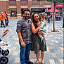 Hitaanshi joined the competition — help win amazing prizes! family, child, toddler, man, woman, outdoor, urban, pavement, stroller, tree, building, window, people, smiling, casual_clothing, holding, footwear, sidewalk, daytime, group