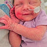 Avery is registered to the contest to win money with this photo: newborn, baby, infant, sleeping, smile, onesie, purple_clothing, medical_tube, feeding_tube, blanket, soft, peaceful, cute, face, hand, skin, resting, indoors, closeup, portrait