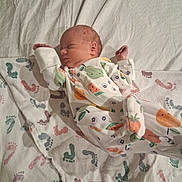 Avery joined the competition — help win amazing prizes! newborn, baby, sleeping, blanket, footprints, onesie, fruit_pattern, infant, sleep, cute, cozy, soft_lighting, peaceful, clothing, bed, child, portrait, resting, indoor, person