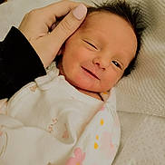 Kylie joined the competition — help win amazing prizes! newborn, baby, smiling, hand, blanket, floral, wrapped, infant, face, sleepwear, cute, portrait, lying_down, soft, cozy, skin, person, expression, happy, resting