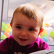 Elena a rejoint le concours — aidez-le/la à gagner de superbes lots ! baby, child, smiling, face, eyes, teeth, hair, purple_clothing, playpen, ball_pit, colorful_balls, indoor, infant, cute, happy, portrait, closeup, soft_surface, fun, play