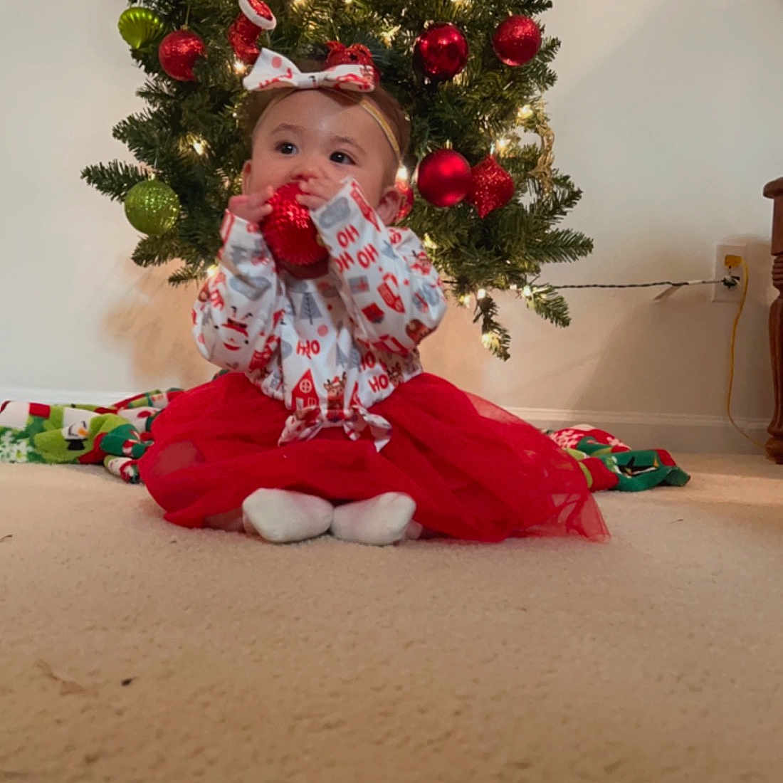 Mahina Hokulani is registered to the contest to win money with this photo: carmine, christmas, christmas_decoration, christmas_ornament, christmas_tree, conifer, dress, event, evergreen, flooring, hat, holiday, holiday_ornament, lap, ornament, plant, santa_claus, toy, tradition, tree