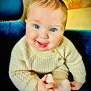 Walter joined the competition — help win amazing prizes! baby, blue_eyes, smile, knit_sweater, cozy, sock, hand, chair, plush, cute, portrait, infant, child, indoor, happy, candid, person, young, seated, warm