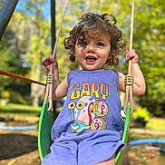 Addison joined the competition — help win amazing prizes! toddler, child, swing, outdoor, playground, curly_hair, purple_outfit, cartoon_snail, gary, smiling, sunlight, greenery, summer, happy, daylight, rope, fun, park, person, nature