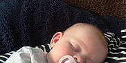 Amelia joined the competition — help win amazing prizes! baby, blanket, child, comfort, couch, cozy, face, head, indoor, infant, napping, pacifier, peaceful, person, relaxation, rest, sleeping, soft_texture, striped_clothing, toddler