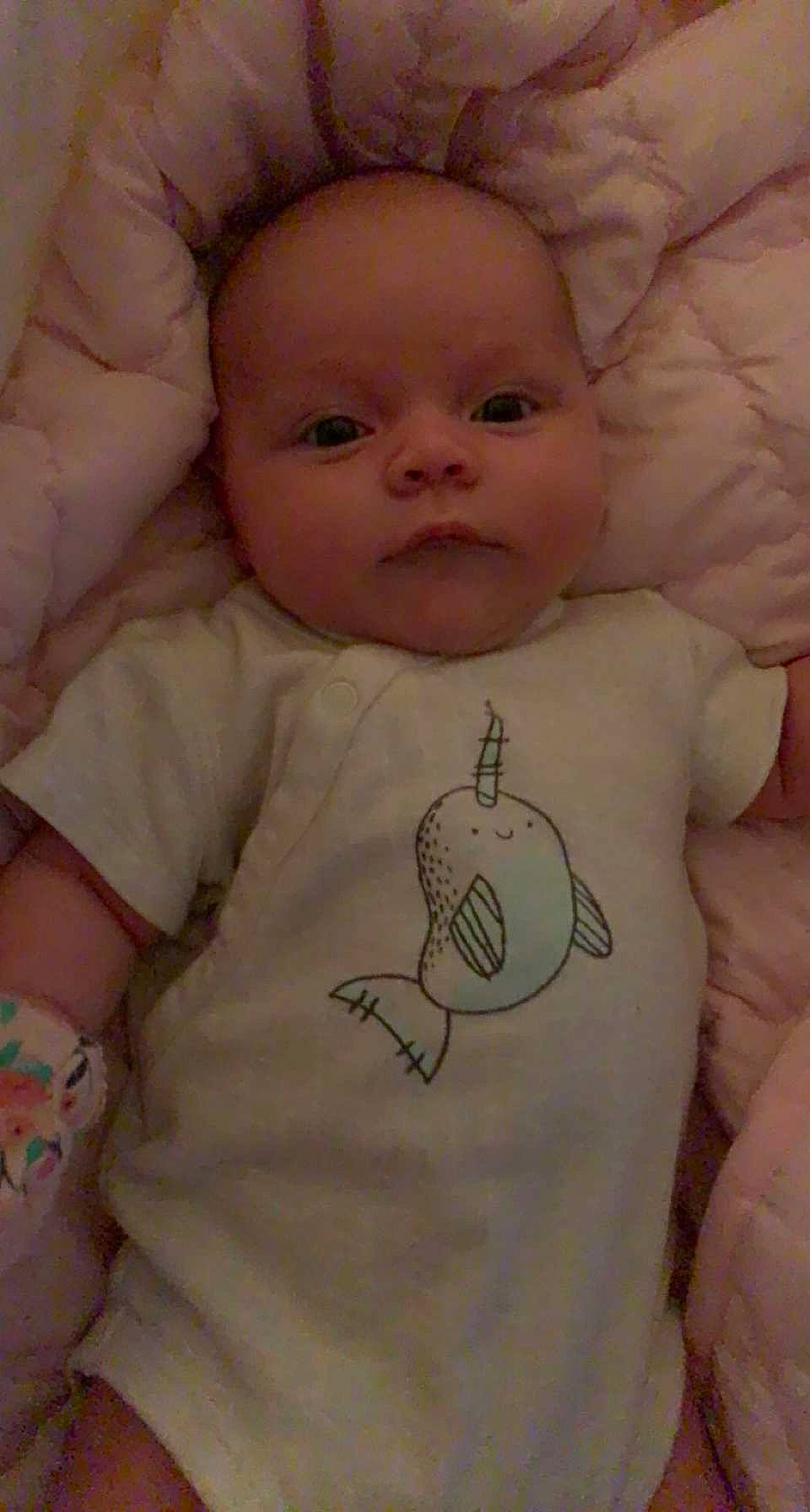 Lillie is registered to the contest to win money with this photo: baby_toddler_clothing, cheek, chin, eyebrow, face, facial_expression, head, human_body, lip, mammal, mouth, neck, nose, organ, person, product, skin, sleeve, textile, vertebrate