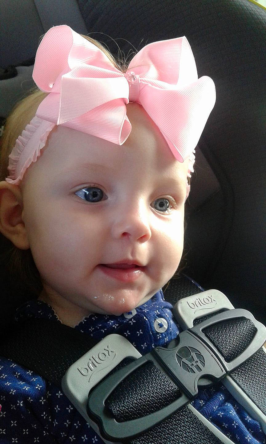 Grace is registered to the contest to win money with this photo: cheek, child, ear, eye, forehead, girl, hair_accessory, head, headband, headgear, infant, person, pink, product, skin, smile, toddler