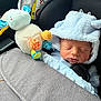 Tommy is registered to the contest to win money with this photo: baby, sleeping, car_seat, plush_toy, blue_outfit, hood, ears, infant, child, cute, soft_toy, safety, seatbelt, car_interior, peaceful, newborn, clothing, fabric, resting, comfort