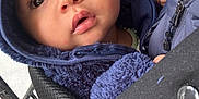 Leo is registered to the contest to win money with this photo: baby, child, face, hoodie, blue_clothing, infant, carrier, hand, curious, closeup, warm_clothing, cute, young_child, portrait, outdoor, brown_eyes, fuzzy_texture, jacket, person, expression