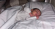 Agustin is registered to the contest to win money with this photo: baby, sleeping, blanket, bed, pillow, face, infant, peaceful, cozy, indoors, rest, child, soft, white, striped, comfort, hands, head, portrait, peace