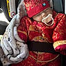 adorable, baby, blanket, car_seat, child, cozy, cute, gold_embroidery, hat, indoors, infant, pacifier, patterned_blanket, portrait, red_clothing, resting, seatbelt, sleeping, traditional_clothing, young_child
