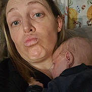 Ezio participe au concours pour gagner de l'argent avec cette photo : woman, baby, face, portrait, indoor, person, sleeping, holding, closeup, expression, skin, hair, head, couch, curtain, clothing, cozy, family, love, affection